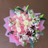 Pink and white rose bouquet with lilies wrapped in pink paper