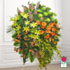 Large standing floral spray with lilies, gerbera daisies, and orchids