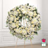 White floral wreath on a standing easel