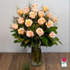 Peach roses arranged in a clear glass vase