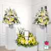White and yellow floral funeral arrangement with matching pedestal sprays