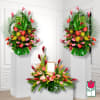 Three tropical floral arrangements with pink and red blooms on white pedestals