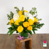 Yellow roses and white hydrangeas in a glass vase with greenery