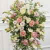 Pastel floral standing spray with pink roses and white calla lilies