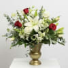 White lilies and red roses in a gold vase