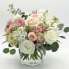 Pink and white rose bouquet in a clear glass vase
