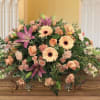 Large casket spray with peach and pink flowers