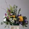 This arrangement with the cross and bright flowers is a reminder this