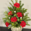 Red carnations in a glittery round vase with evergreen sprigs