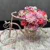 This charming, vintage-inspired arrangement is a masterclass in texture and color, blending