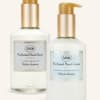 Two pump bottles of scented hand soap and hand cream