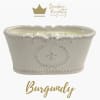 White ceramic candle vessel with gold logo and text
