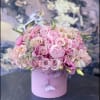 Pink rose bouquet in a round pink hat box