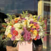 Large mixed bouquet of roses in a pink box