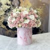 Pink and white rose arrangement in a pink marbled hatbox
