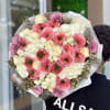 Large bouquet of pink and white flowers wrapped in white paper
