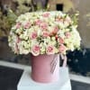 Pink and white rose bouquet in a pink hat box with ribbon