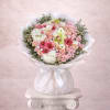 Large round bouquet of pink spray roses and white hydrangeas wrapped in white paper and ribbon