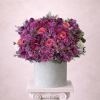 Pink and purple rose arrangement in a gray hat box