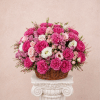 Basket of pink and white roses on a pedestal