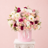 Pink and white rose bouquet in a pink hatbox with ribbon and pearls