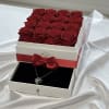 Box of red roses with a necklace in a drawer below