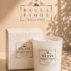 White scented candle with matching box on a beige surface