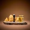 Lip balm, two small glass jars, and amber stones on a wood slab