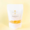 White candy bag labeled Champagne Gummies on a pale yellow background