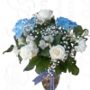 White and blue flower bouquet in a glass vase with ribbon