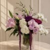 Pink and white floral arrangement in a glass vase