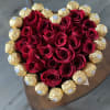 Heart-shaped bouquet of red roses surrounded by gold-wrapped chocolates