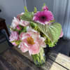 Pink and white bouquet in a glass vase with a bright pink gerbera daisy