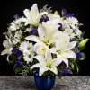 Big, luminous white lilies take center stage in this elegant flower arrangement