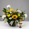 Mixed bouquet with sunflowers, white carnations, and yellow daisies in a black container