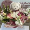Pink and white bouquet with lilies, roses, and a teddy bear