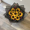 Bouquet of sunflowers and red roses wrapped in black paper