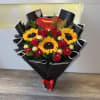 Bouquet of red roses and sunflowers with chocolates and a heart balloon