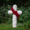 White and red floral cross on a stand