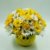 Yellow and white flowers arranged in a smiley-face pot