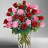 Bouquet of red and pink roses in a clear glass vase