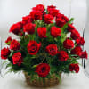 Basket of red roses with greenery