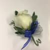 White rose boutonniere with blue ribbon and greenery