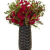 Magenta flower arrangement in a tall black vase