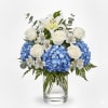 An elegant and tranquil arrangement, where lush blue hydrangeas create a cloud-like