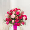 Pink and red rose bouquet in a bright pink vase