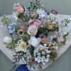 A gorgeous wild bouquet of natural stems including pretty nuances of blue.