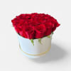 Red roses arranged in a round white hat box