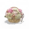 Pink and white flower arrangement in a wicker basket