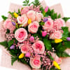 A graceful bouquet featuring premium blush pink roses, cheerful tulips, delicate pink